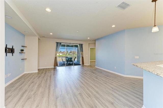 unfurnished living room featuring light hardwood / wood-style floors