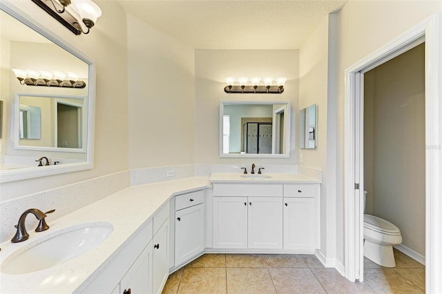 bathroom featuring tile patterned floors, vanity, and toilet