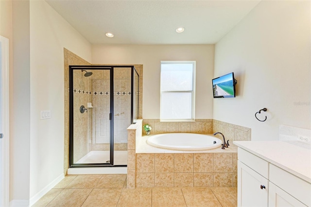 bathroom with tile patterned flooring, vanity, and separate shower and tub