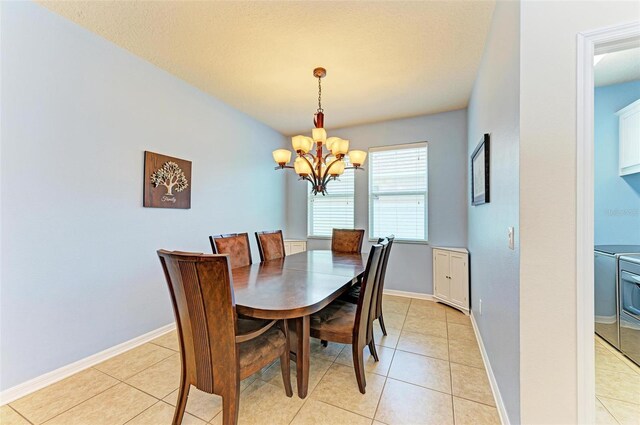 dining area featuring light tile patterned flooring and a notable chandelier