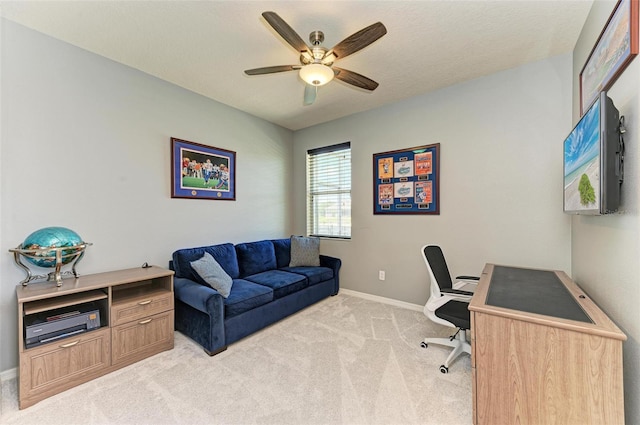 carpeted home office with ceiling fan and a textured ceiling