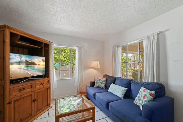 living room with light tile patterned floors and a textured ceiling