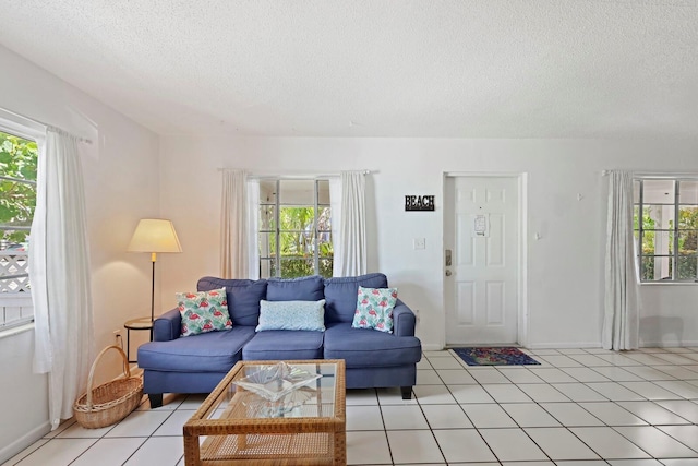 living room with light tile patterned flooring and a textured ceiling