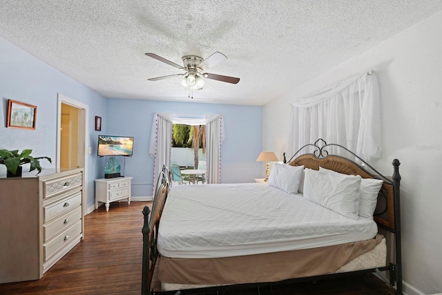 bedroom with ceiling fan, dark hardwood / wood-style floors, and a textured ceiling