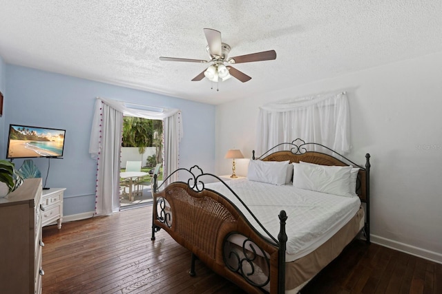 bedroom with a textured ceiling, ceiling fan, and dark wood-type flooring