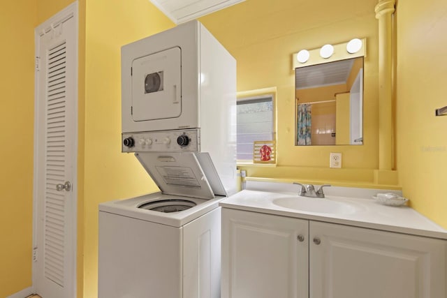 laundry room with stacked washer / drying machine, ornamental molding, and sink