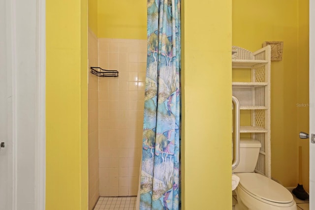 bathroom with a shower with shower curtain, toilet, and tile patterned floors