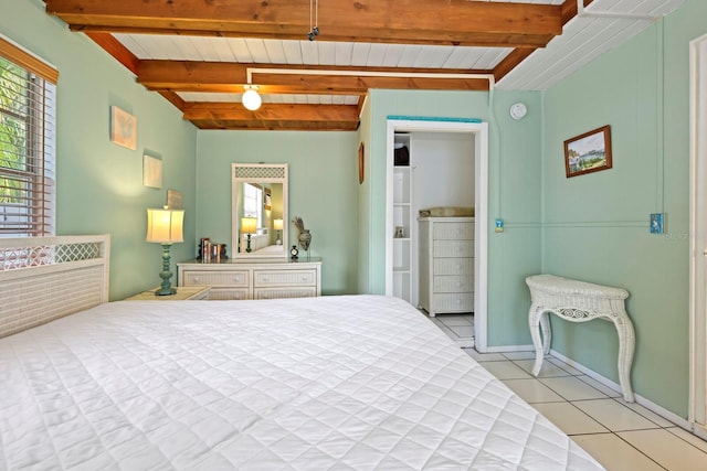 tiled bedroom featuring beam ceiling and wood ceiling