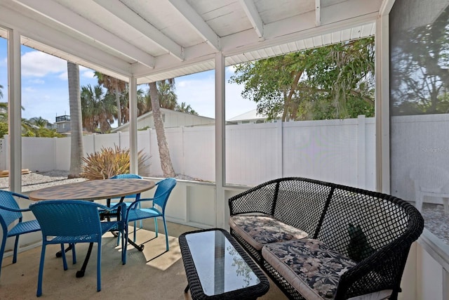 sunroom / solarium with beam ceiling and a wealth of natural light