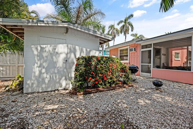 view of property exterior featuring a sunroom