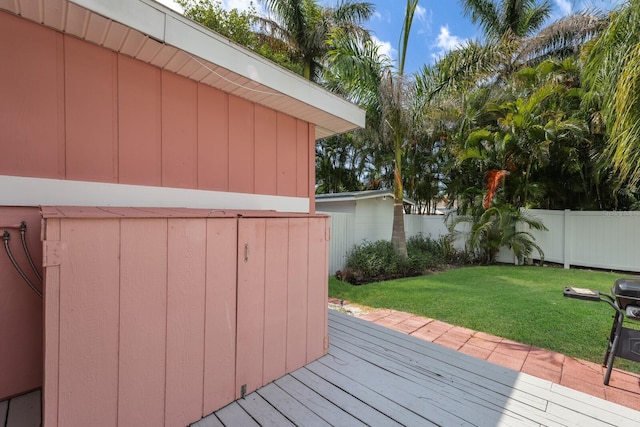 wooden deck featuring a yard