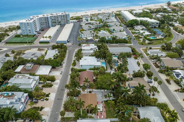 birds eye view of property with a beach view and a water view