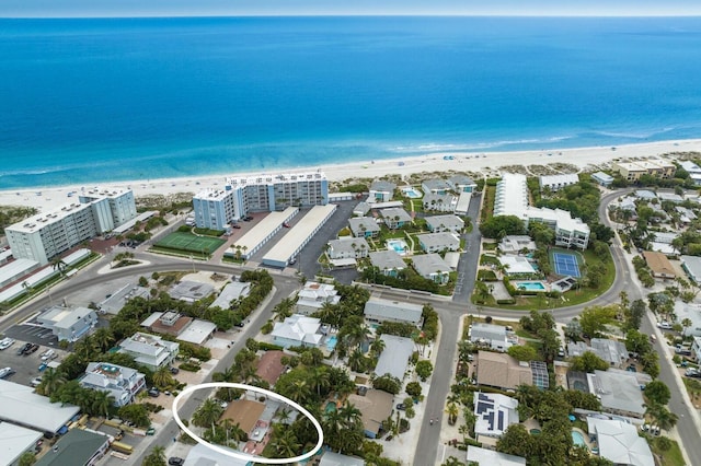 drone / aerial view with a beach view and a water view