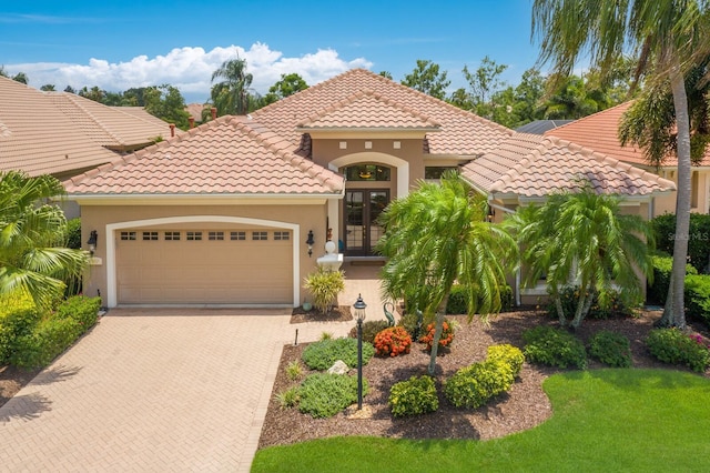 mediterranean / spanish-style house with french doors and a garage