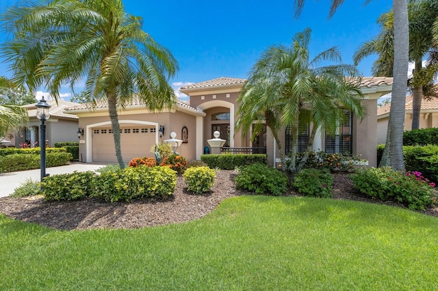 mediterranean / spanish home featuring a front yard and a garage