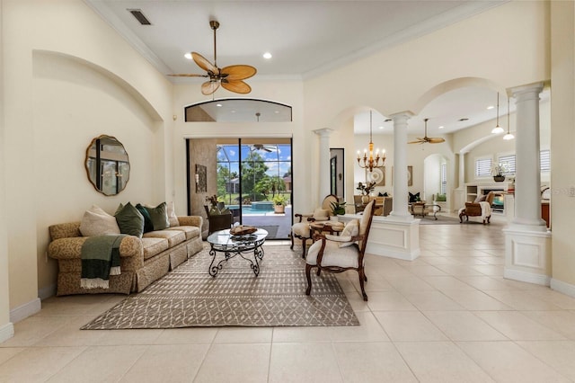 tiled living room featuring ornamental molding, ceiling fan, and ornate columns