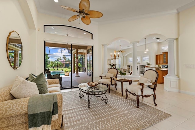 tiled living room with ornamental molding, ceiling fan, and ornate columns