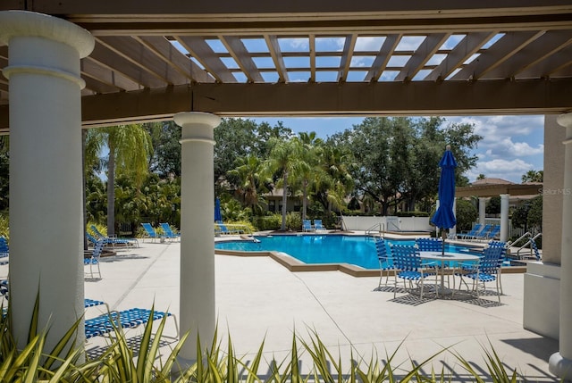 view of swimming pool featuring a patio area and a pergola