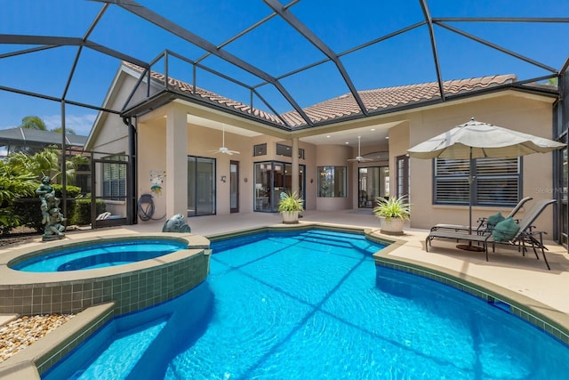 view of pool featuring an in ground hot tub, ceiling fan, a patio, and glass enclosure