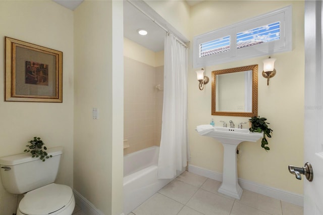 bathroom featuring shower / bath combination with curtain, toilet, and tile patterned flooring