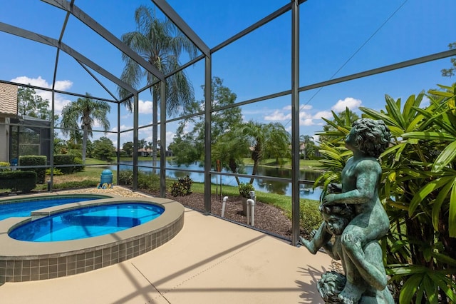 view of pool with an in ground hot tub, a water view, glass enclosure, and a patio area