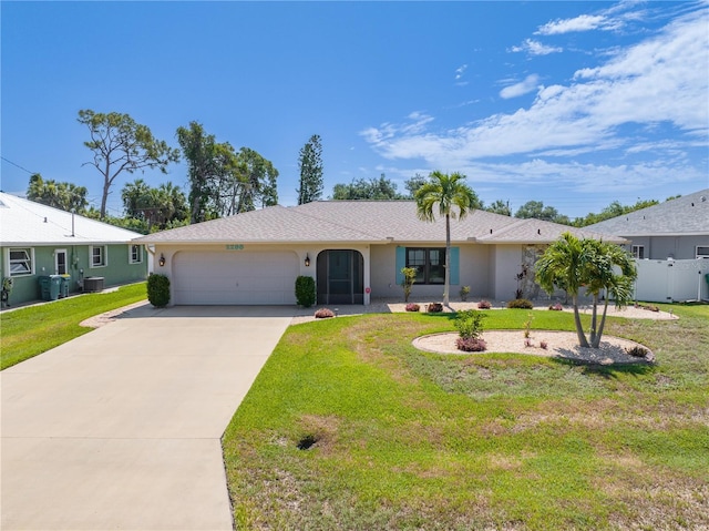 single story home with a front yard, central AC, and a garage