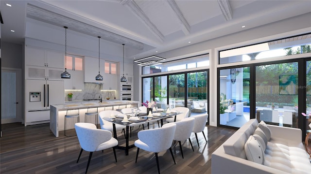 dining space with sink, beamed ceiling, dark wood-type flooring, and high vaulted ceiling