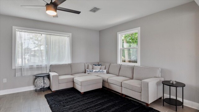 living room with ceiling fan and hardwood / wood-style flooring