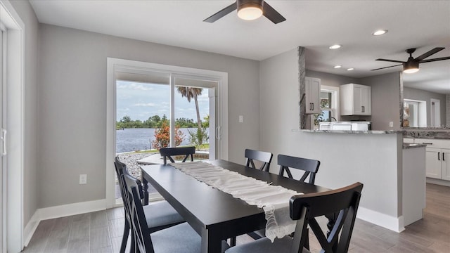 dining area featuring ceiling fan and dark hardwood / wood-style flooring