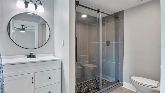 bathroom with walk in shower, ceiling fan, vanity, and toilet