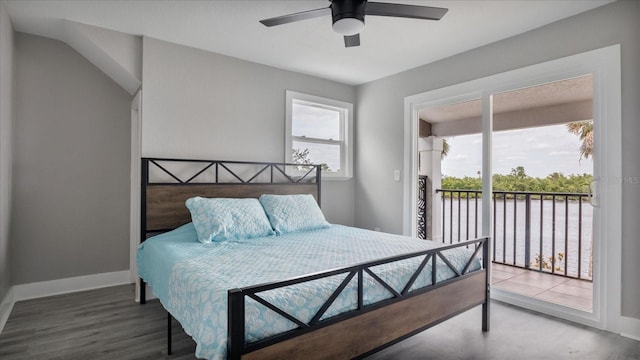 bedroom with access to exterior, ceiling fan, a water view, and hardwood / wood-style flooring