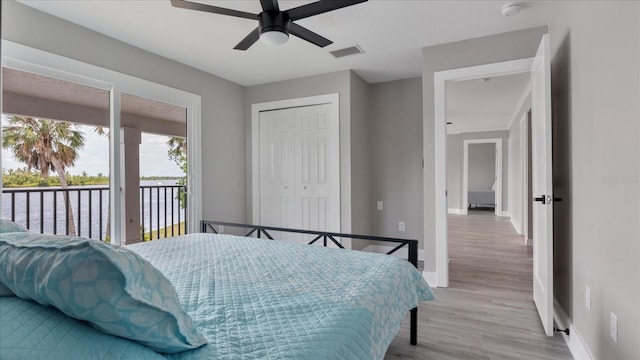 bedroom featuring ceiling fan, light wood-type flooring, access to outside, and a closet