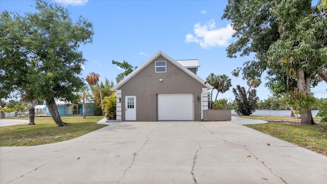 view of side of property featuring a yard and a garage