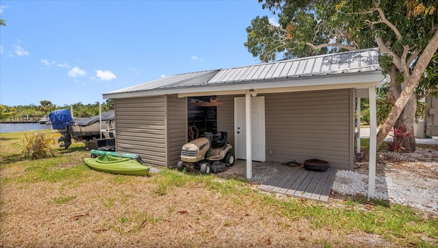 view of outdoor structure featuring a yard and a water view