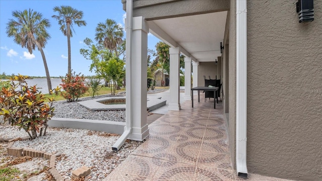 view of patio with a water view