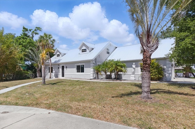 9610 SW Yacht Dr, Arcadia, FL 34269 - cape cod home featuring metal roof, a front yard, and stucco siding