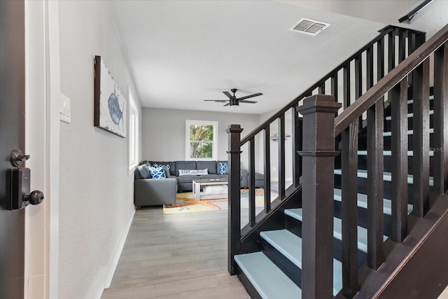 9610 SW Yacht Dr, Arcadia, FL 34269 - stairs with a ceiling fan, wood finished floors, and visible vents