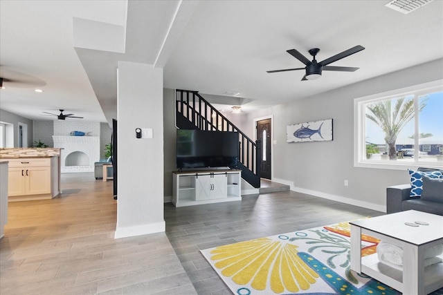 9610 SW Yacht Dr, Arcadia, FL 34269 - living area featuring visible vents, stairs, baseboards, light wood-type flooring, and a ceiling fan