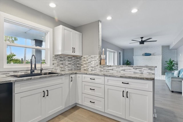 9610 SW Yacht Dr, Arcadia, FL 34269 - kitchen with a ceiling fan, a sink, white cabinets, a peninsula, and open floor plan