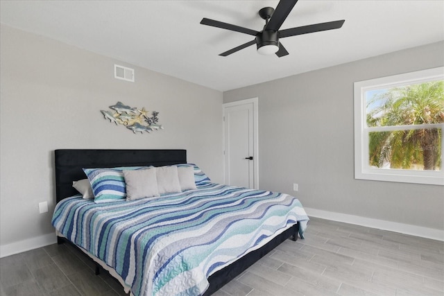 9610 SW Yacht Dr, Arcadia, FL 34269 - bedroom with baseboards, ceiling fan, wood finish floors, and visible vents