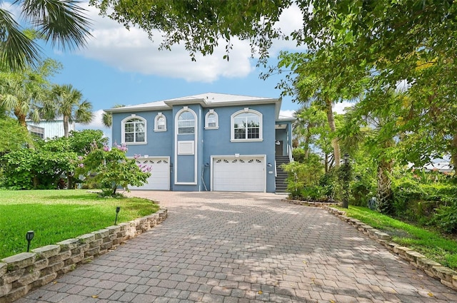 view of front of house with a front yard and a garage