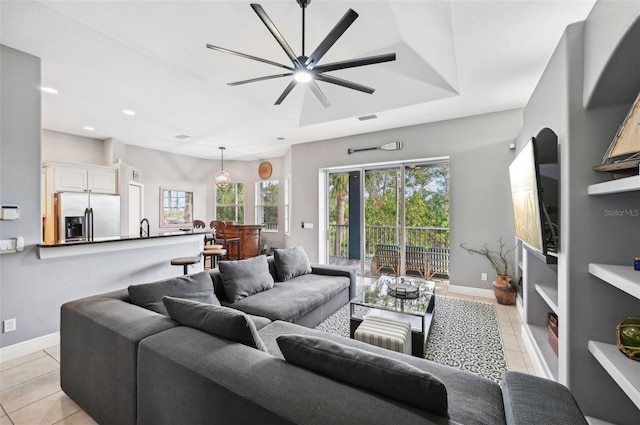 tiled living room with ceiling fan