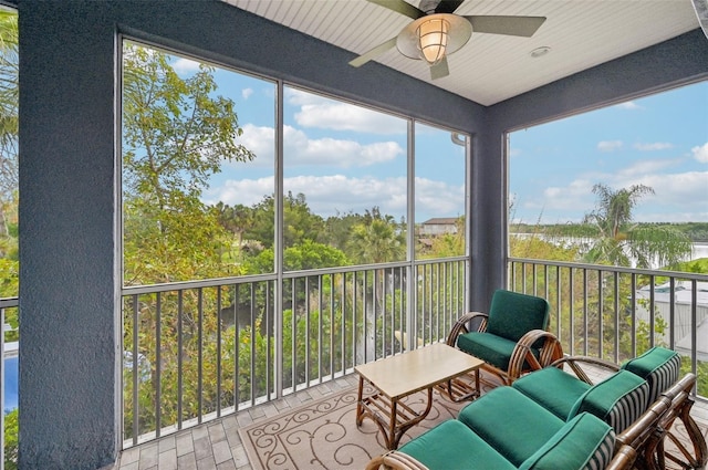 sunroom featuring ceiling fan