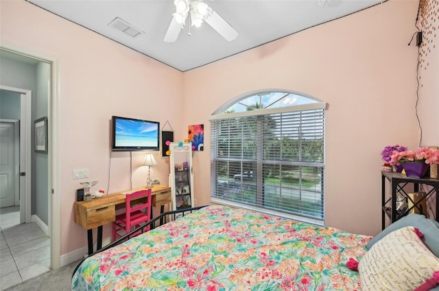 bedroom with ceiling fan and tile patterned flooring