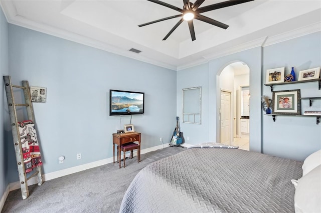 bedroom featuring a raised ceiling, ceiling fan, light colored carpet, and ornamental molding