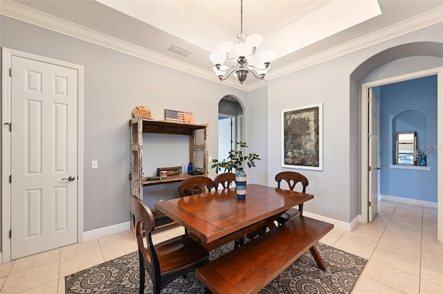 tiled dining area with crown molding and a notable chandelier