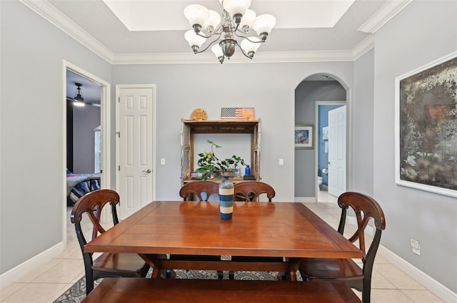 tiled dining room with ceiling fan with notable chandelier and ornamental molding