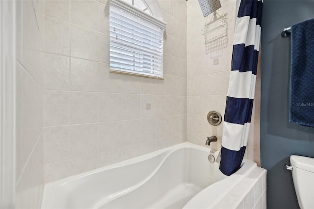 bathroom featuring toilet and shower / bathtub combination with curtain