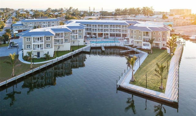 exterior space with a water view and a fenced in pool