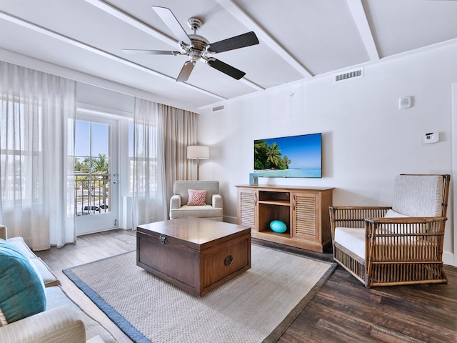 living room featuring beam ceiling, ceiling fan, and hardwood / wood-style floors